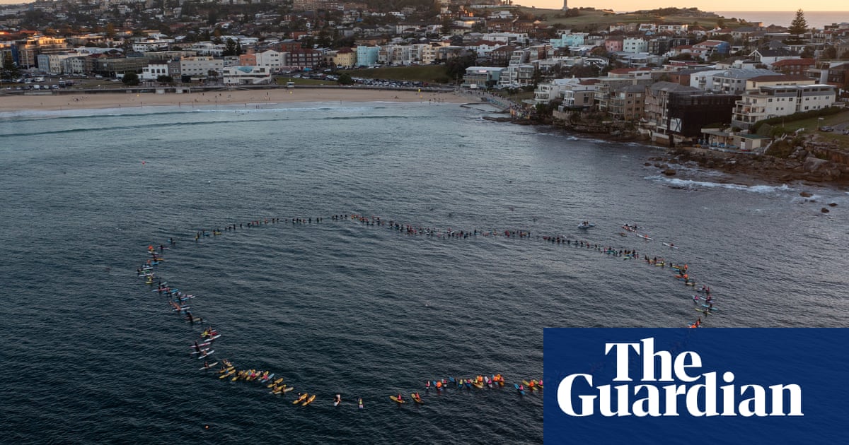 Hundreds honour Westfield stabbing victims with paddle-out at Bondi beach – video | Australia news
