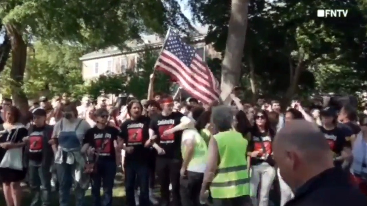 Rutgers students with American flag counter anti-Israel protest with 