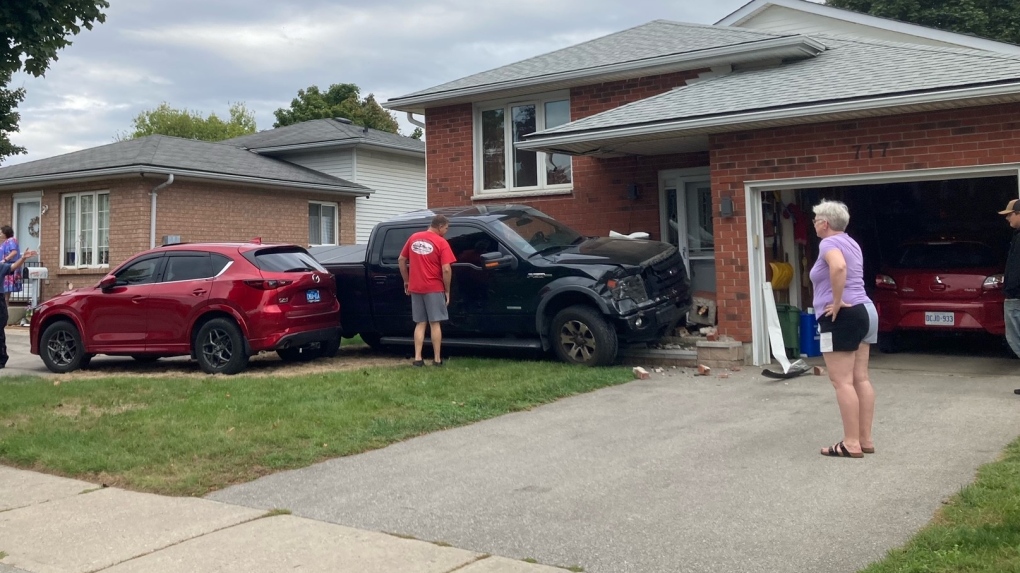 Truck hits parked car then house [Video]